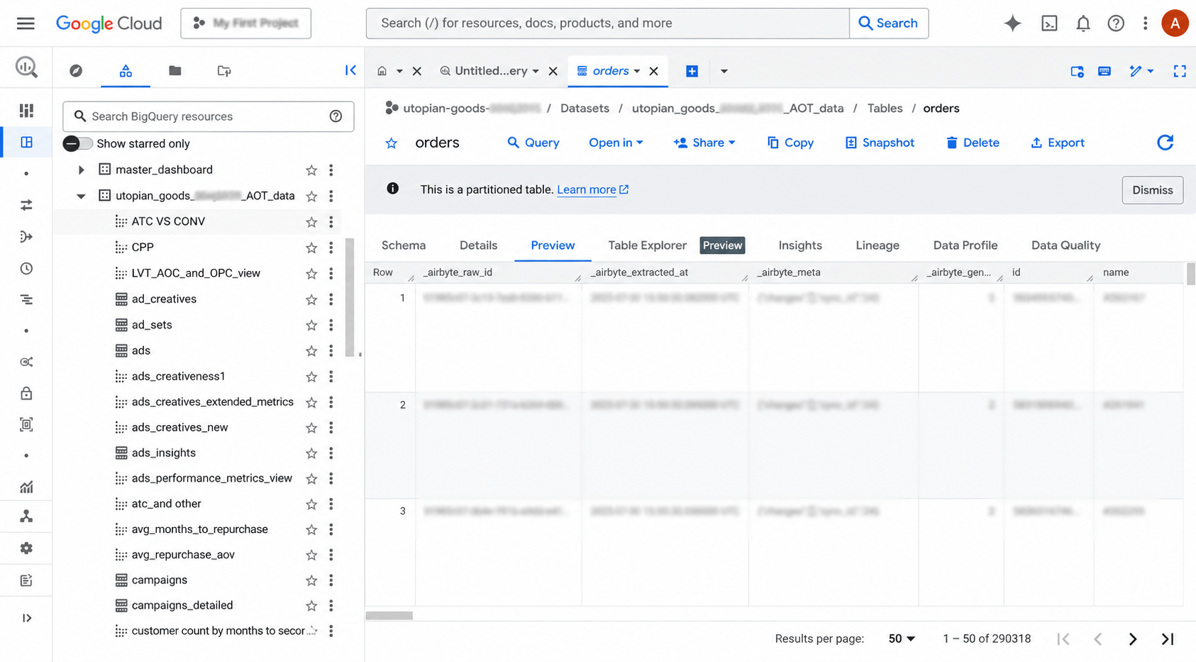 BigQuery AOT dataset showing orders partitioned table with 290K rows and multiple analytics views